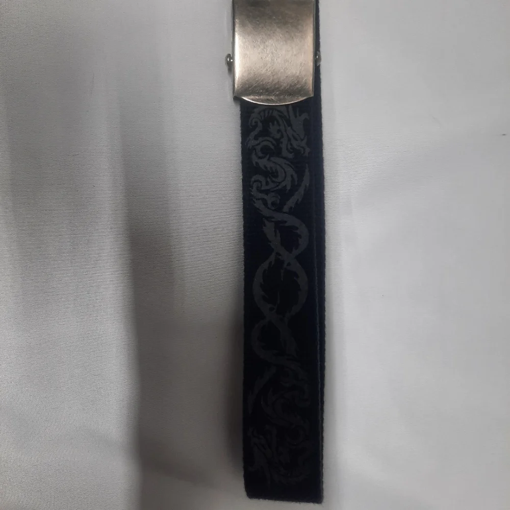 Reversible black belt, side 1 is black w/ grey dragons & side 2 is solid Black